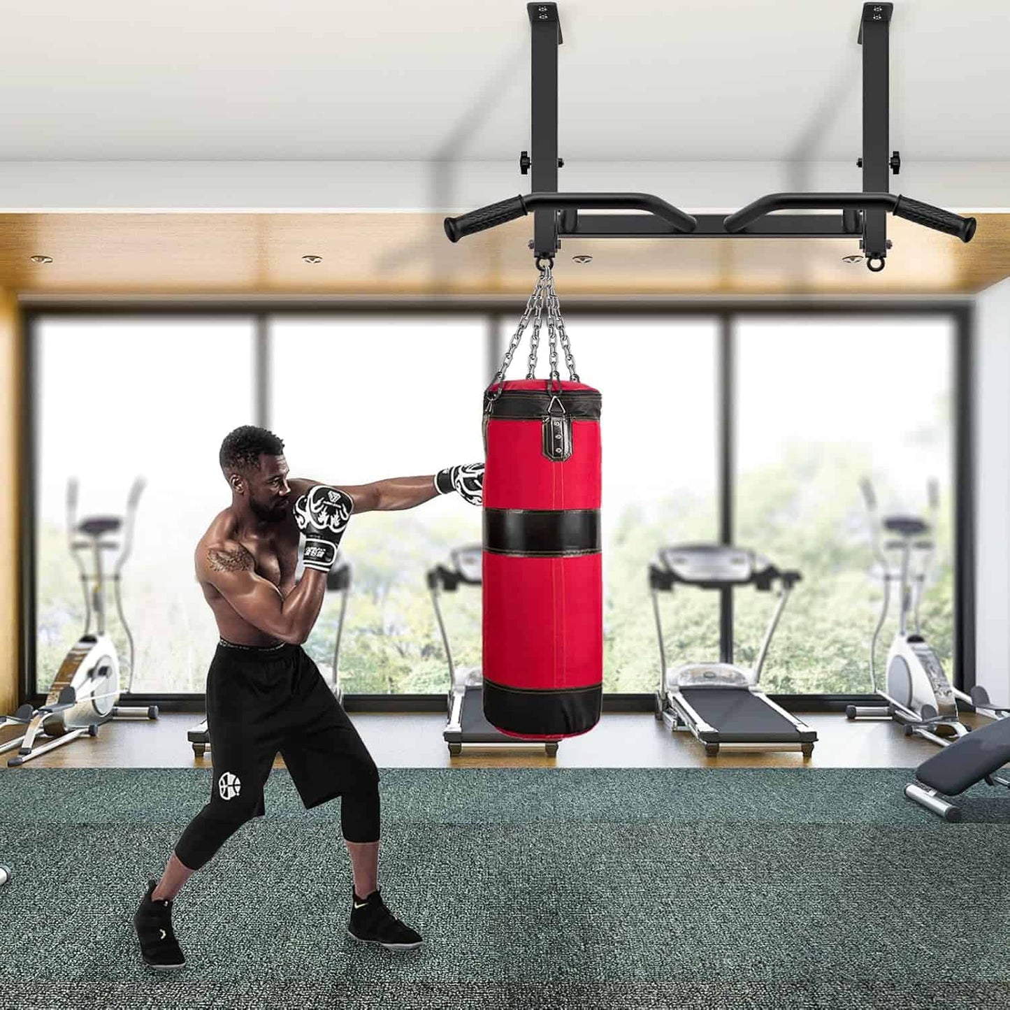 Person training with a red punching bag in a gym setting