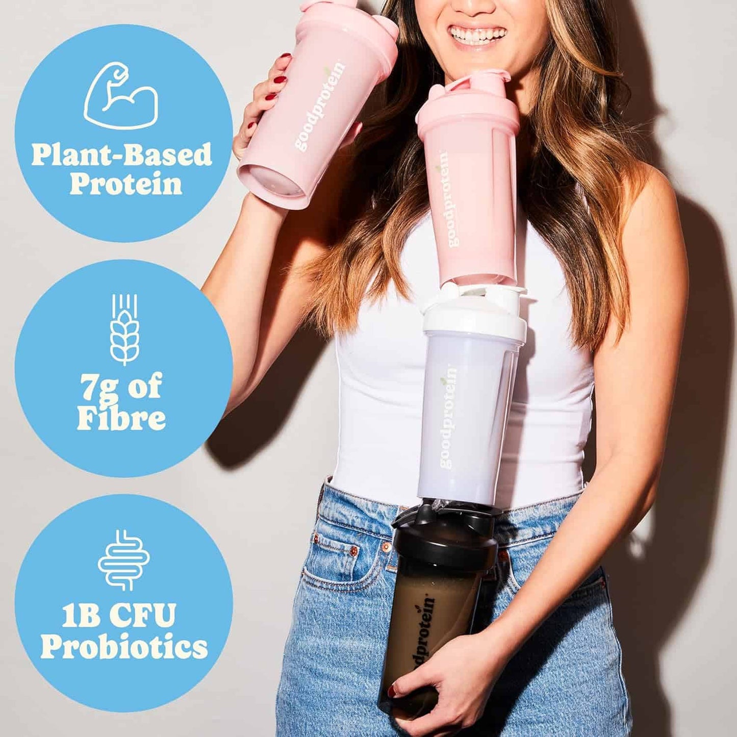 Woman holding a protein shaker with health benefits displayed on a light background