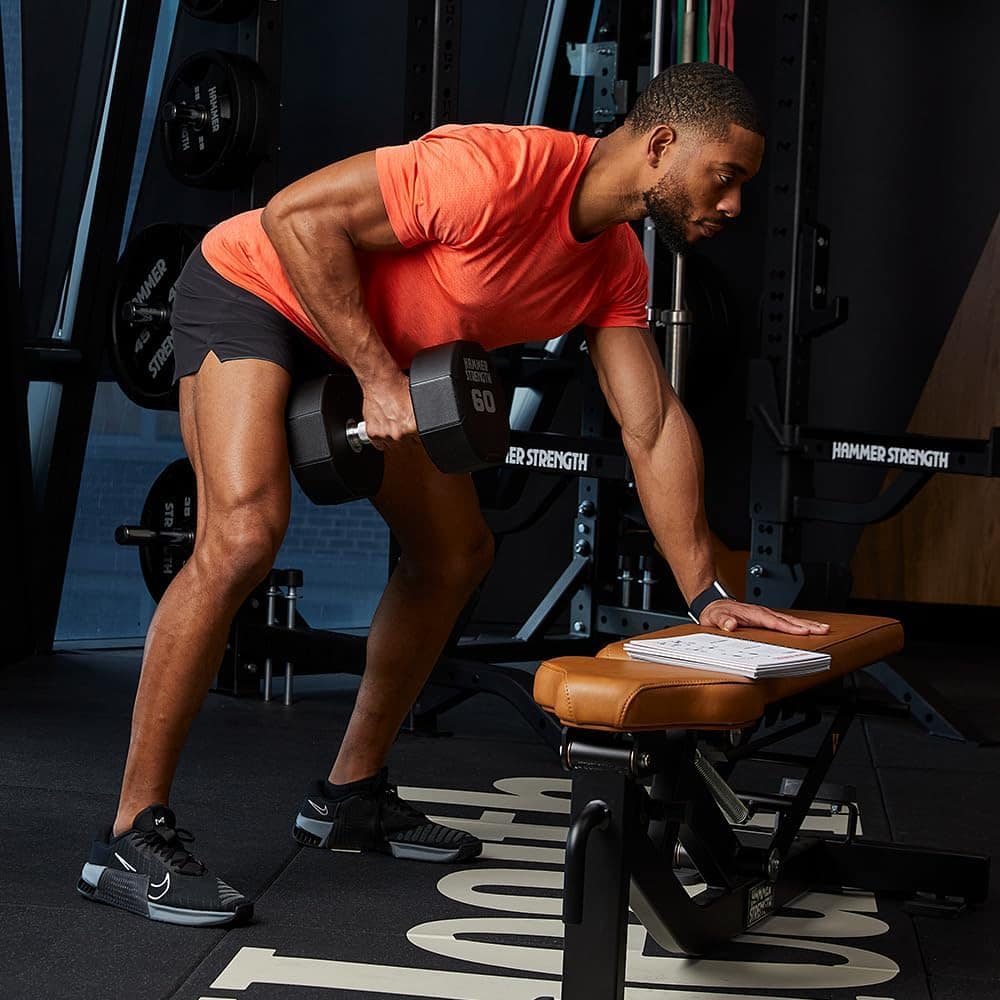 Man lifting weights in a gym setting