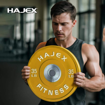Man holding a yellow Hajex fitness weight plate in a gym setting