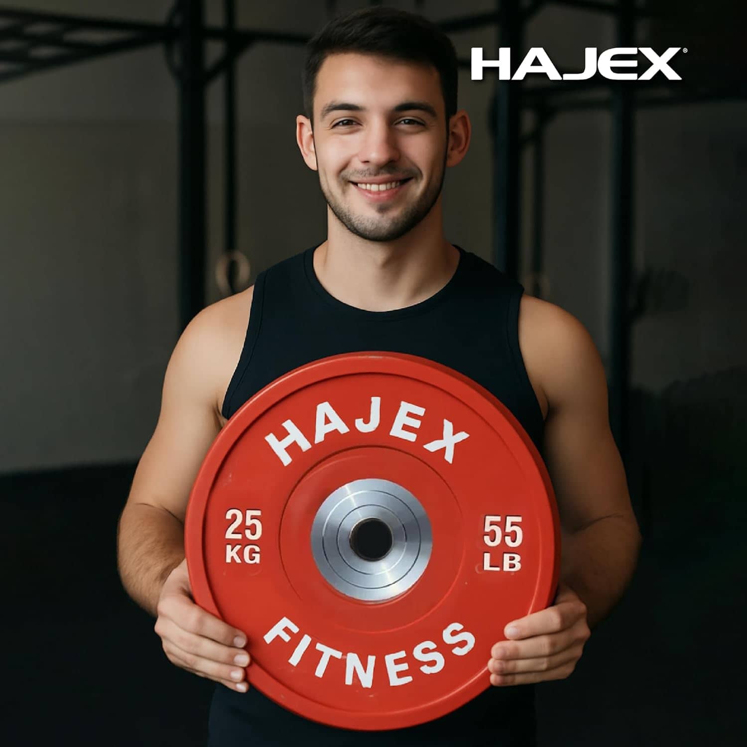 Man holding a red HAJEX fitness weight plate in a gym setting