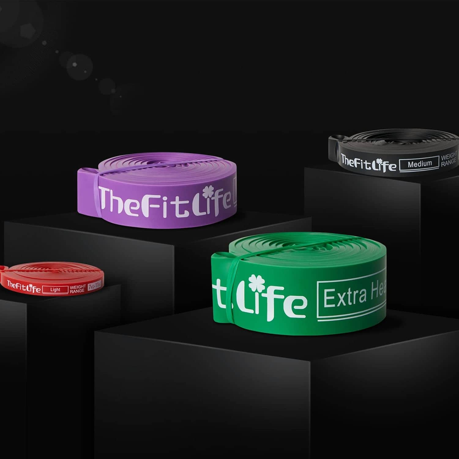 Set of resistance bands from TheFitLife on a black background