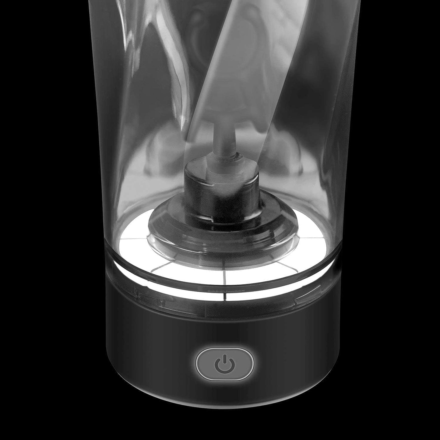 Black and white image of a blender with a power button on a black background