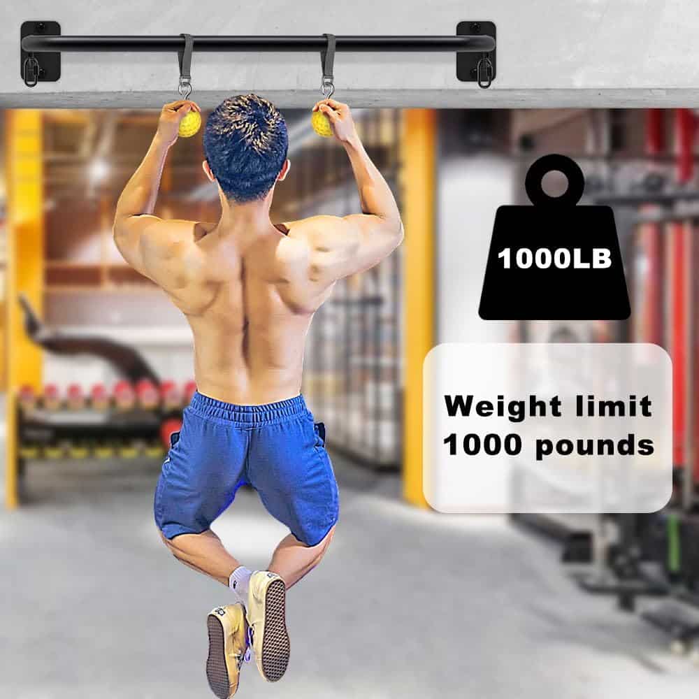 Person doing pull-ups on a bar with a weight limit label in a gym setting