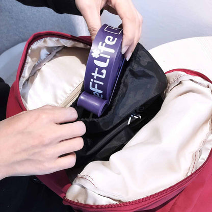 Person placing a purple 'Fit Life' product into a red bag.