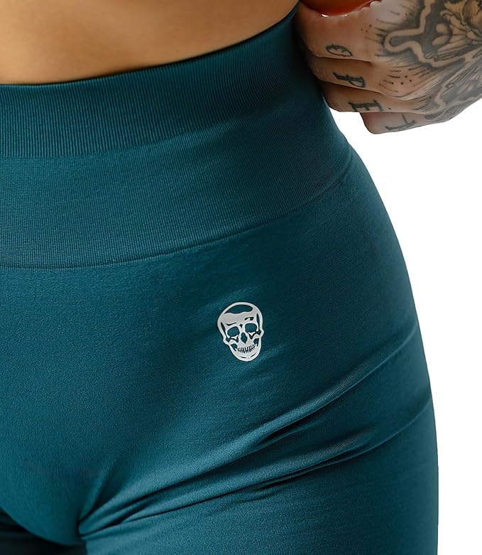 Teal leggings with a skull logo on a white background