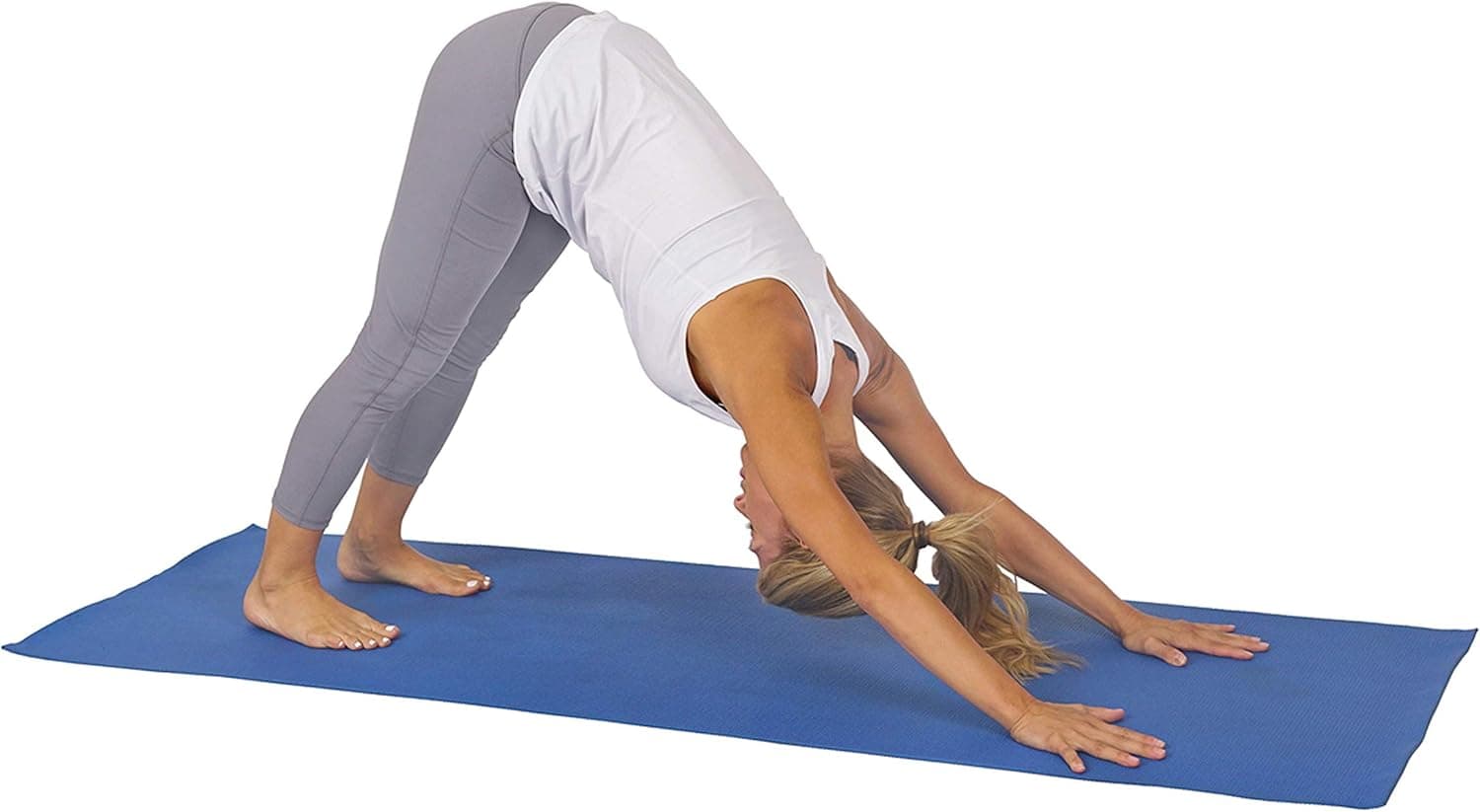 Person performing a yoga pose on a blue mat with a white background