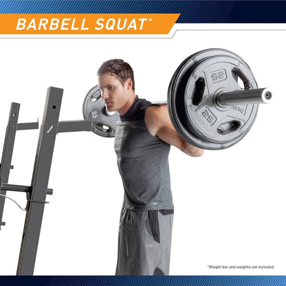 Man performing a barbell squat with a weight rack in the background