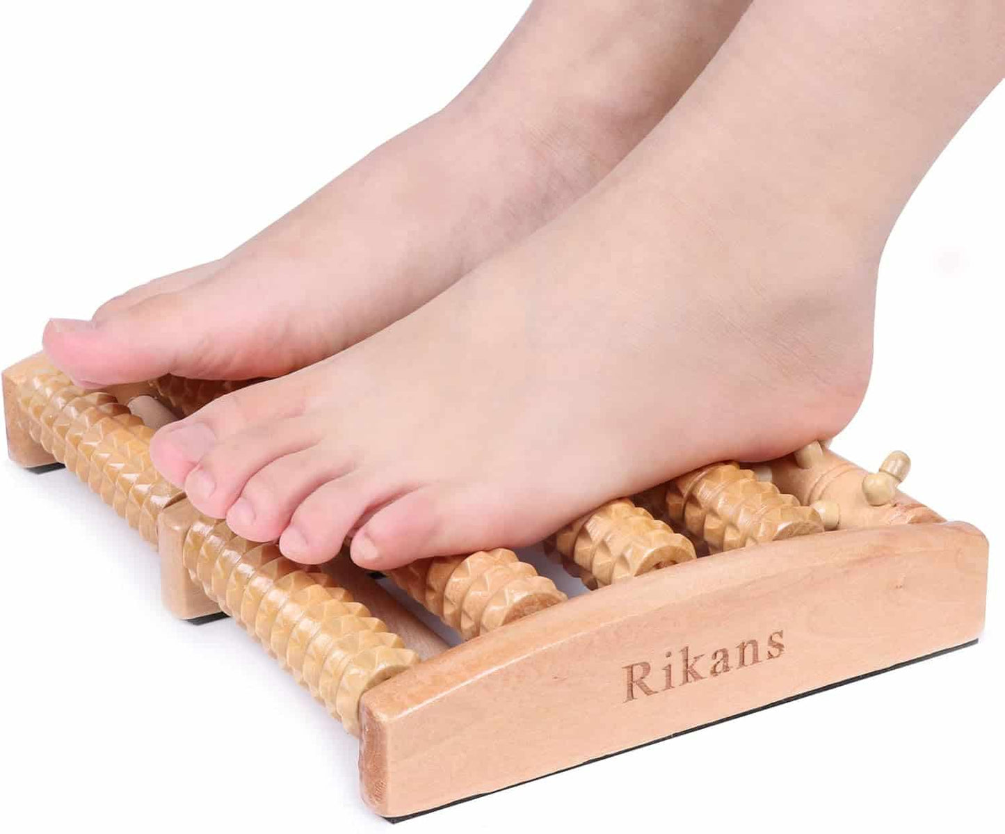 Wooden foot massager with feet on a white background