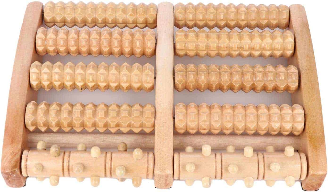 Wooden massage roller with multiple rows of cylindrical rollers on a white background