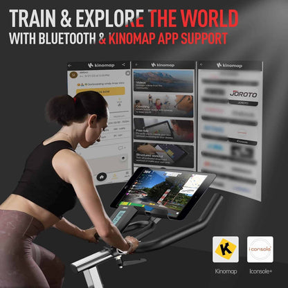 Woman exercising on a bike with digital screens displaying app interfaces, promoting Bluetooth and Kinomap app support.