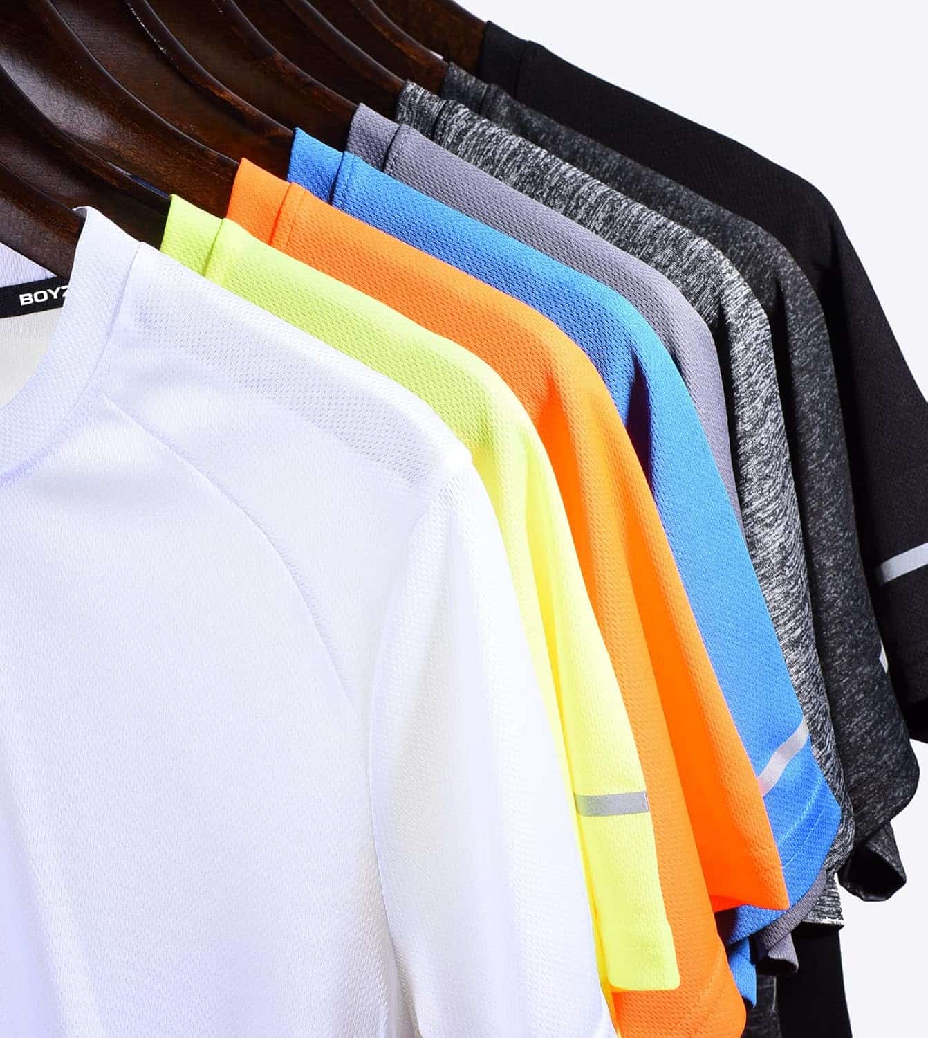 Row of colorful shirts on hangers against a white background