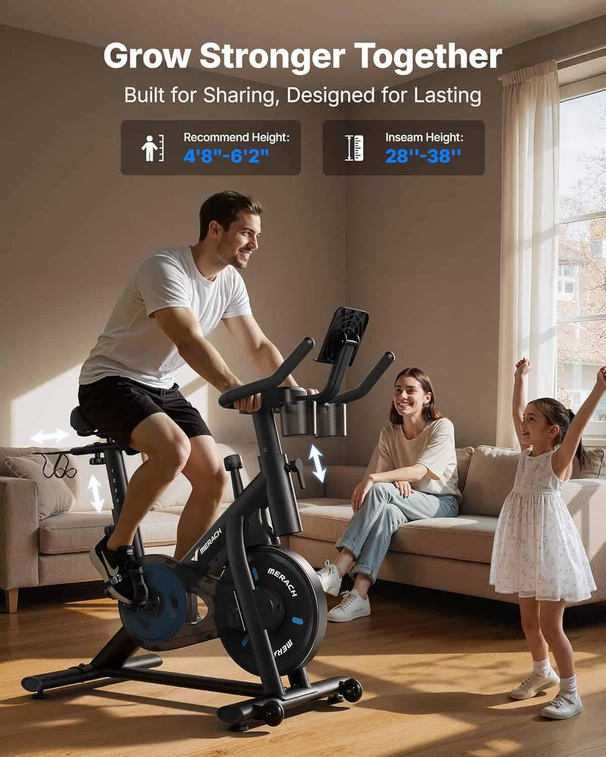 Man using a stationary bike in a living room with a woman and child watching.