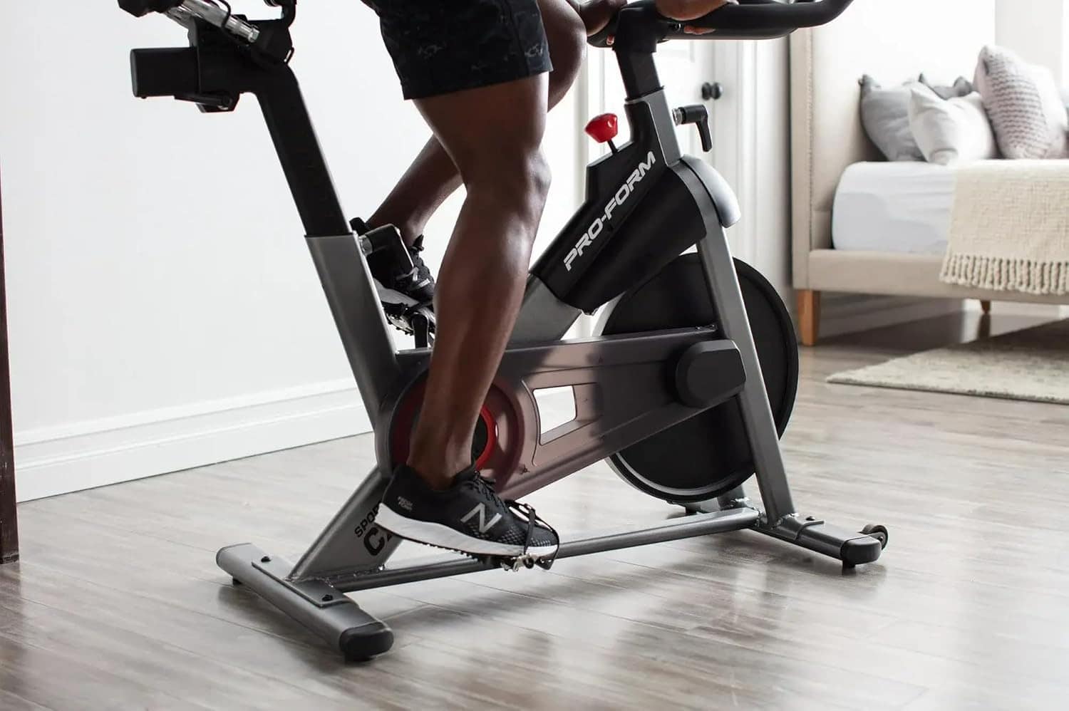 Person using a Peloton bike in a home setting
