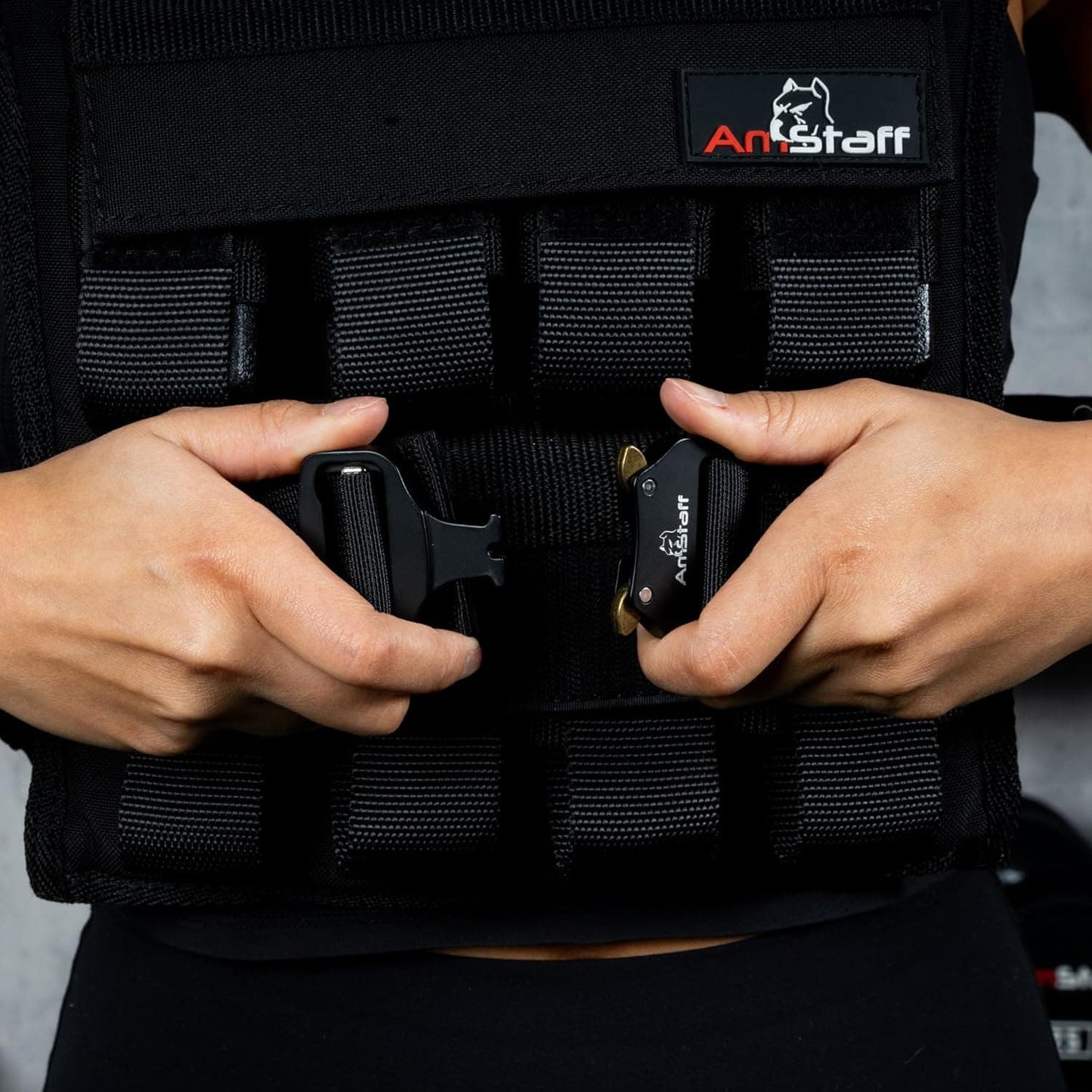 Person wearing a black tactical vest with visible ArtStaff branding.