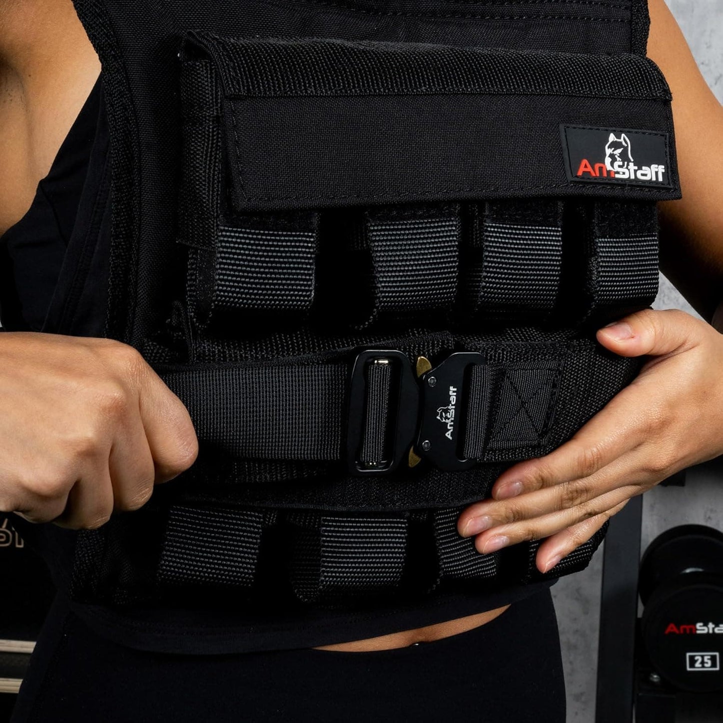Person wearing a black weighted vest with 'ArtStaff' branding.