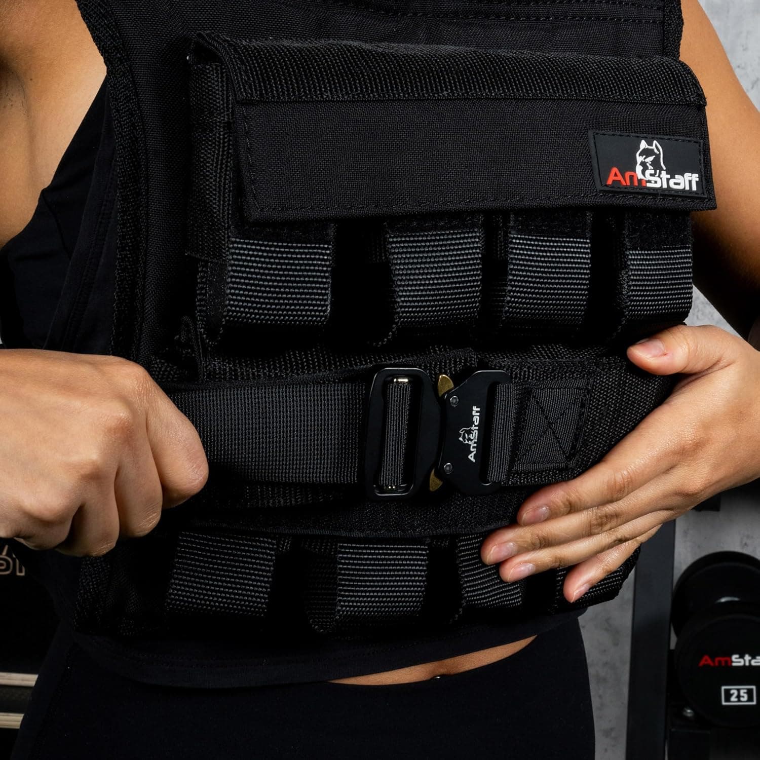Person wearing a black weighted vest with 'ArtStaff' branding.