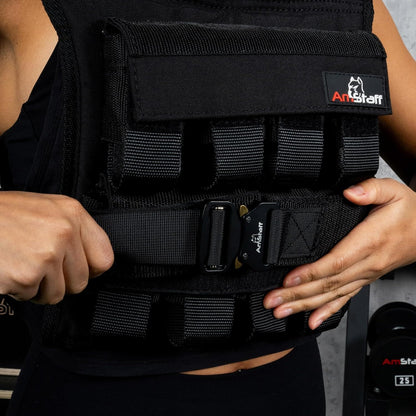 Person wearing a black weighted vest with 'ArtStaff' branding.