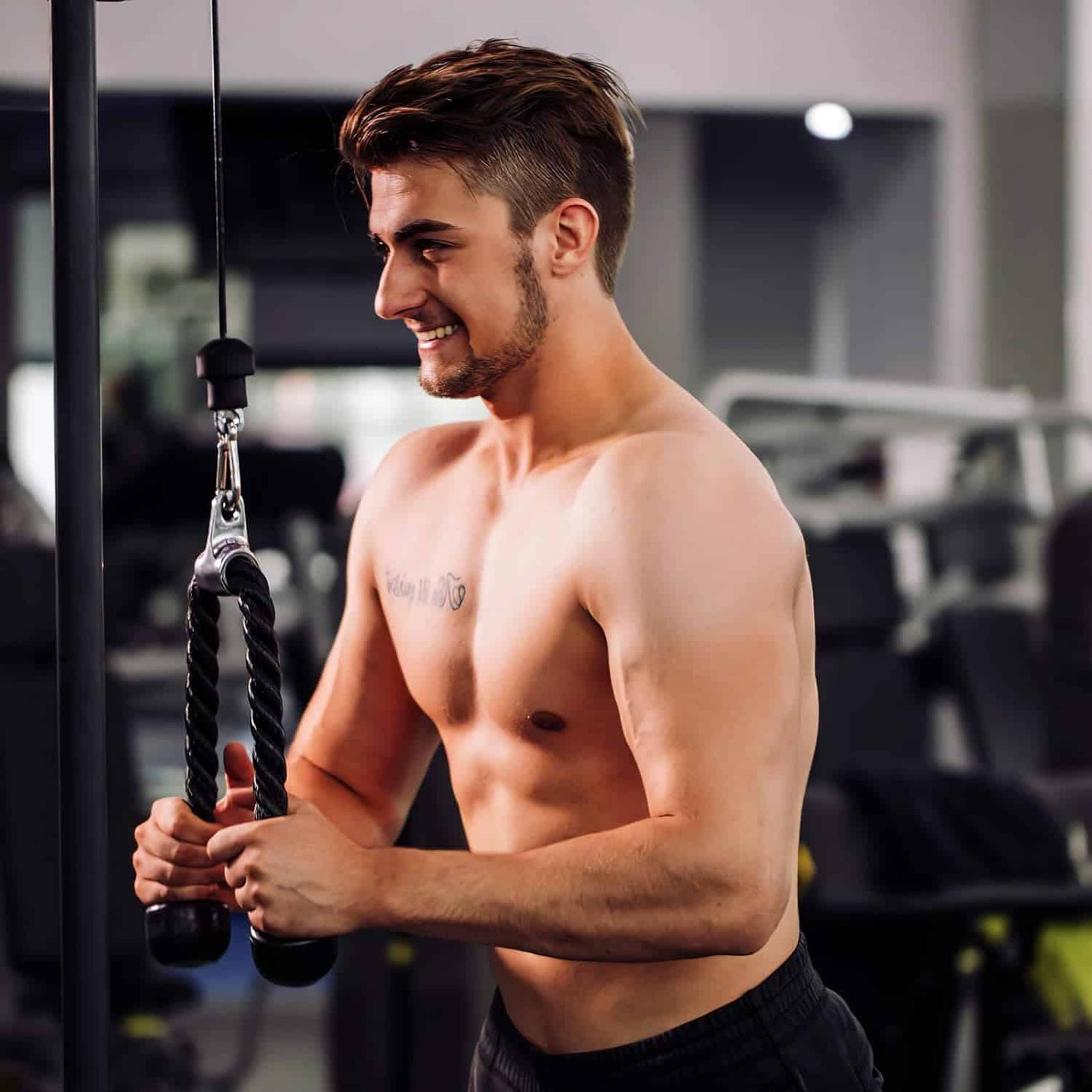 Man exercising with a rope in a gym setting