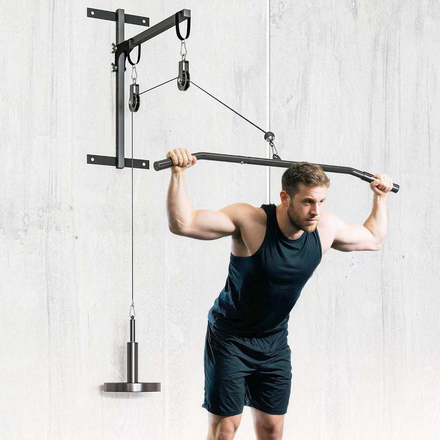 Man using a pull-up bar with weight attachments against a light gray wall.